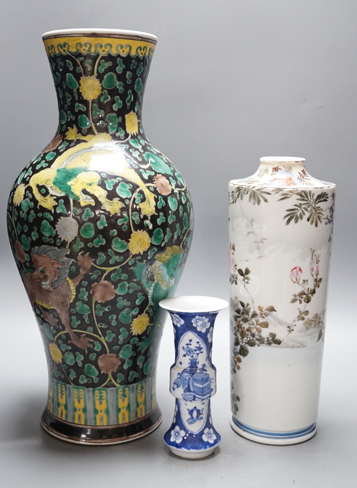 A Chinese famille noire vase, a Chinese blue and white small gu vase and a Japanese cylindrical vase, tallest 43cms high